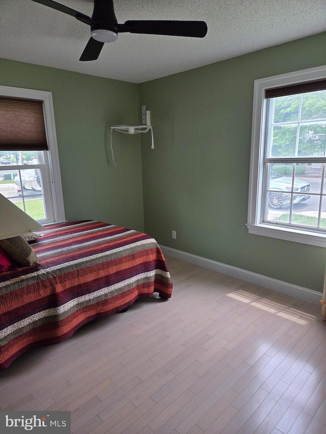 156 Captains Quarters Rd, Ocean City, MD 21842 - bedroom with a textured ceiling, wood finished floors, and ceiling fan