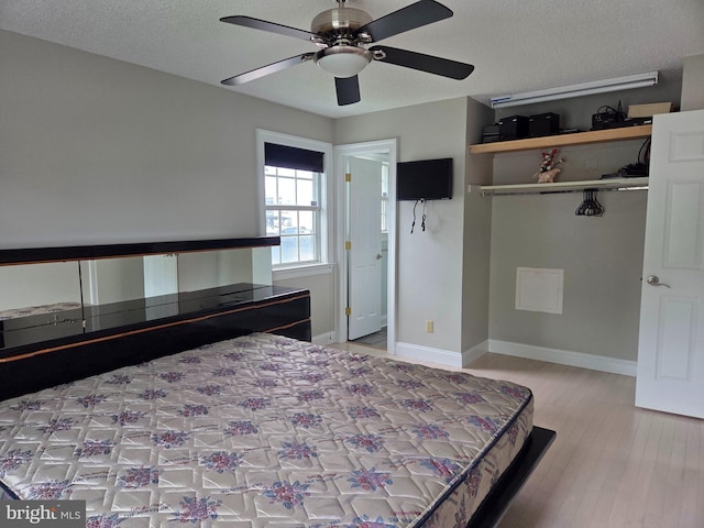 156 Captains Quarters Rd, Ocean City, MD 21842 - bedroom featuring wood finished floors, a textured ceiling, and a ceiling fan