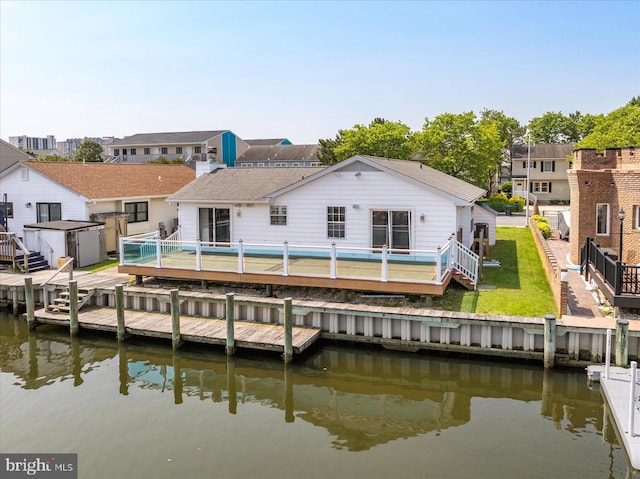 156 Captains Quarters Rd, Ocean City, MD 21842 - rear view of house featuring a deck with water view, a storage shed, a residential view, and a fenced backyard