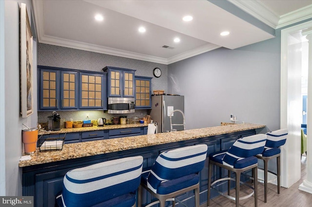 8607 Wintergreen Ct Unit 204, Odenton, MD 21113 - kitchen featuring stainless steel appliances, crown molding, wood finished floors, a peninsula, and glass insert cabinets