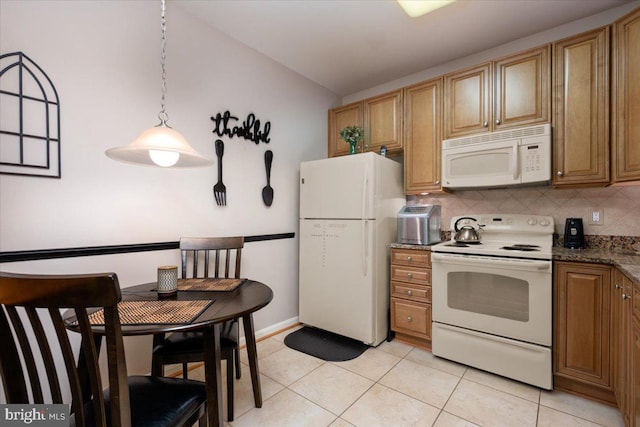 8607 Wintergreen Ct Unit 204, Odenton, MD 21113 - kitchen with white appliances, light tile patterned flooring, tasteful backsplash, hanging light fixtures, and vaulted ceiling