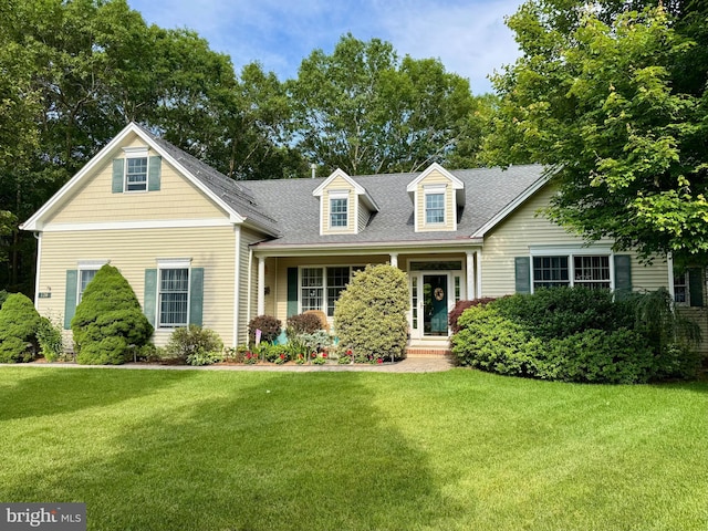 128 Rowan Ct, Manahawkin, NJ 08050 - cape cod home with a front yard and roof with shingles