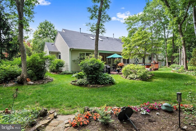 128 Rowan Ct, Manahawkin, NJ 08050 - back of property with a yard, a shingled roof, and a patio