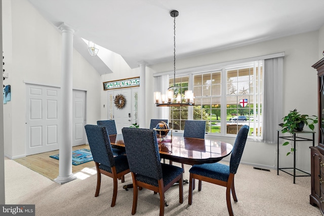 128 Rowan Ct, Manahawkin, NJ 08050 - carpeted dining space featuring a chandelier, ornate columns, and lofted ceiling
