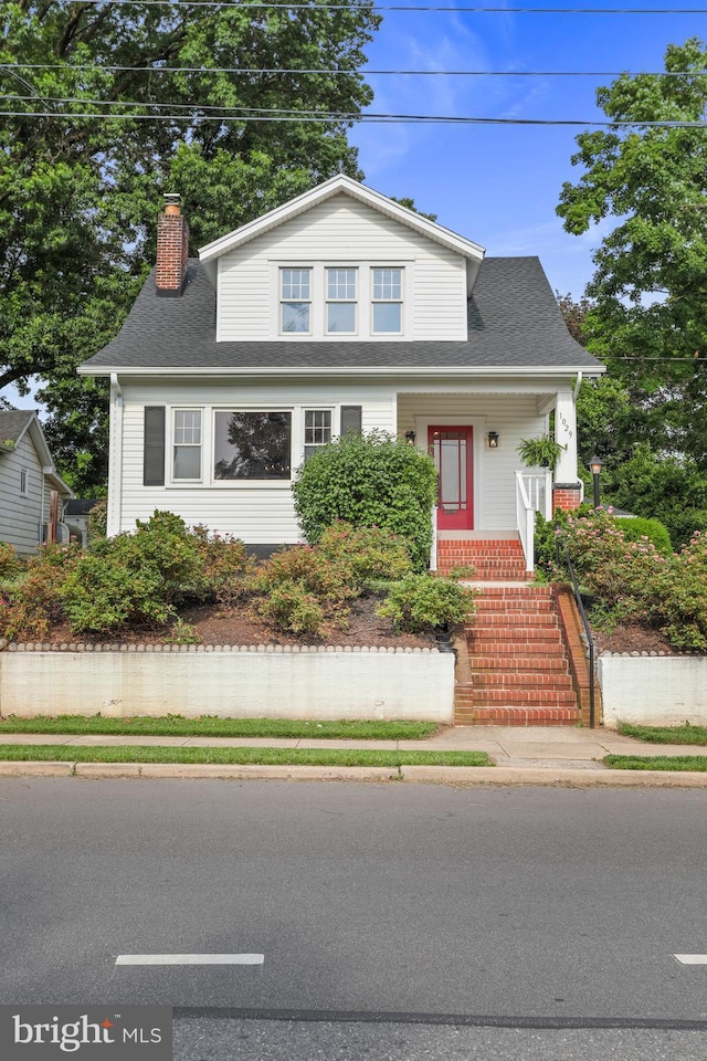 1029 Pennsylvania Ave, Hagerstown, MD 21742 - view of front of home with a chimney, a shingled roof, and stairway