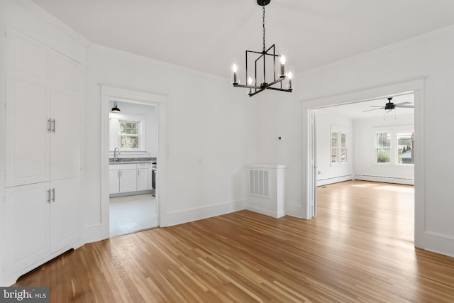1029 Pennsylvania Ave, Hagerstown, MD 21742 - unfurnished dining area featuring plenty of natural light, light wood finished floors, a chandelier, ornamental molding, and ceiling fan