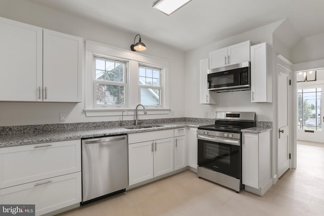 1029 Pennsylvania Ave, Hagerstown, MD 21742 - kitchen featuring stainless steel appliances, white cabinets, and light stone counters