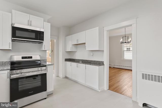 1029 Pennsylvania Ave, Hagerstown, MD 21742 - kitchen featuring electric range, radiator, a baseboard radiator, white cabinets, and a chandelier