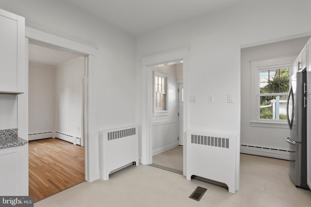 1029 Pennsylvania Ave, Hagerstown, MD 21742 - hallway featuring radiator, baseboard heating, and light floors