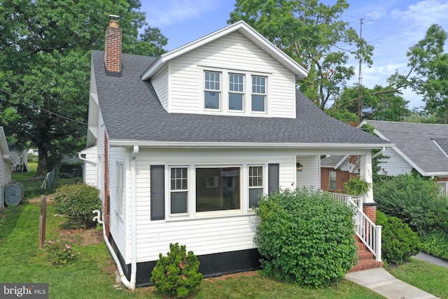 1029 Pennsylvania Ave, Hagerstown, MD 21742 - bungalow with a chimney, a shingled roof, a front lawn, and covered porch