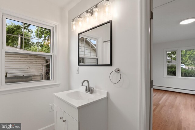 1029 Pennsylvania Ave, Hagerstown, MD 21742 - bathroom featuring vanity, baseboard heating, and wood finished floors