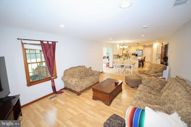 865 Seneca Rd, Great Falls, VA 22066 - living room featuring a chandelier, healthy amount of natural light, light wood-style floors, and recessed lighting