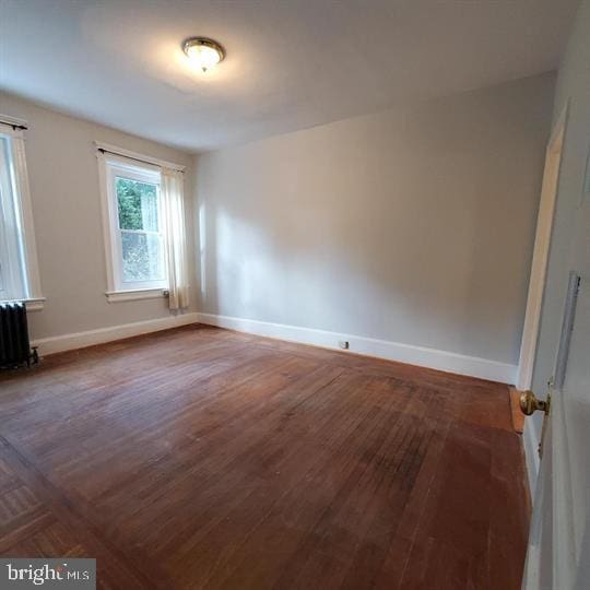 1212 Park Rd NW, Washington, DC 20010 - empty room with radiator heating unit and wood finished floors