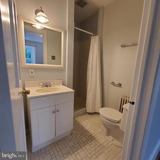 1212 Park Rd NW, Washington, DC 20010 - bathroom with vanity, a shower stall, and radiator heating unit