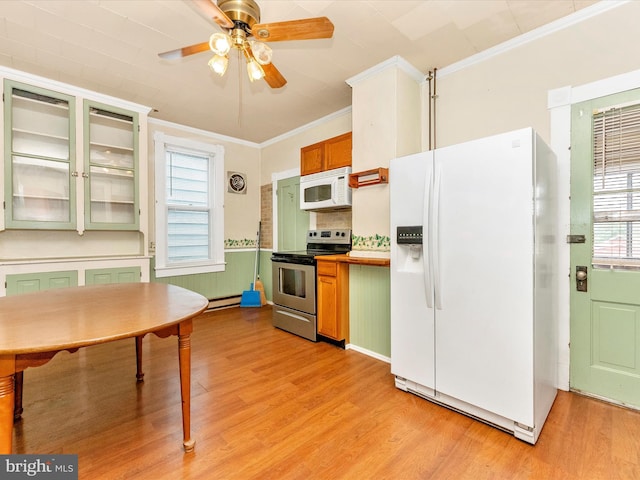526 W Potomac St, Brunswick, MD 21716 - kitchen featuring white appliances, crown molding, light wood-style floors, a ceiling fan, and a baseboard radiator