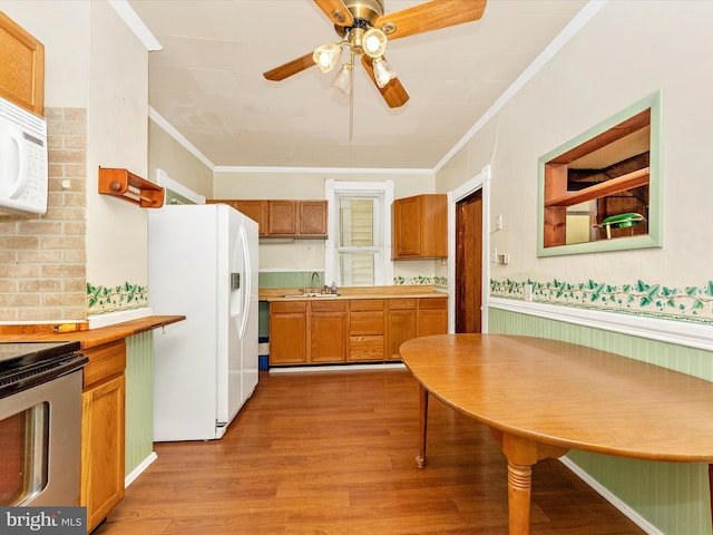 526 W Potomac St, Brunswick, MD 21716 - kitchen with white appliances, ornamental molding, a ceiling fan, light wood-type flooring, and brown cabinetry