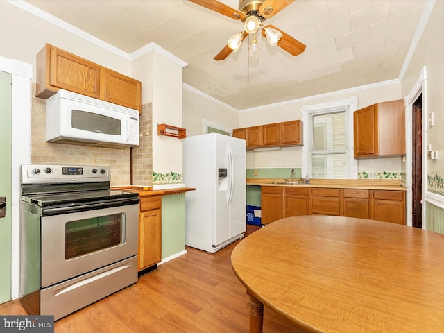 526 W Potomac St, Brunswick, MD 21716 - kitchen featuring white appliances, crown molding, light wood finished floors, a ceiling fan, and light countertops