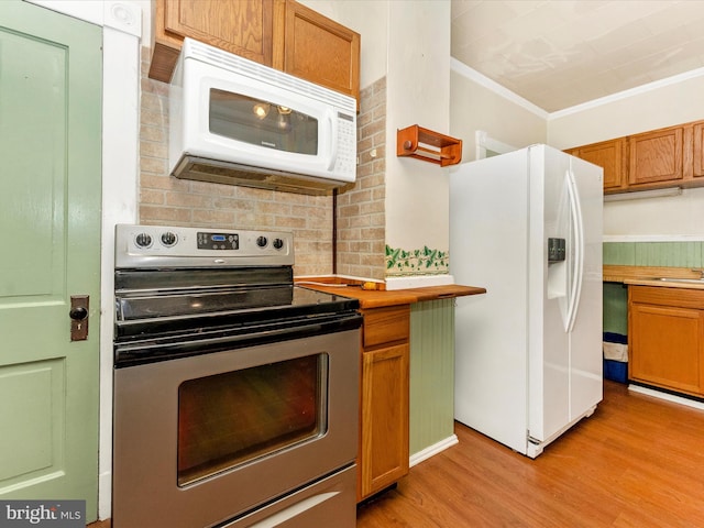 526 W Potomac St, Brunswick, MD 21716 - kitchen with white appliances, light wood finished floors, crown molding, and brown cabinetry