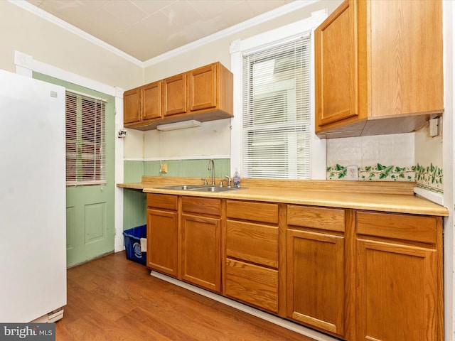 526 W Potomac St, Brunswick, MD 21716 - kitchen featuring freestanding refrigerator, crown molding, wood finished floors, light countertops, and brown cabinetry