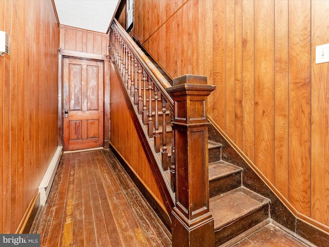526 W Potomac St, Brunswick, MD 21716 - staircase featuring wooden walls, hardwood / wood-style floors, and a baseboard heating unit