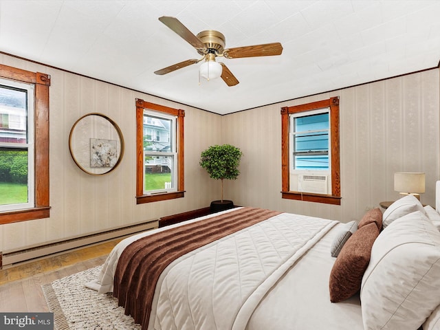 526 W Potomac St, Brunswick, MD 21716 - bedroom featuring hardwood / wood-style floors, cooling unit, a ceiling fan, and baseboard heating