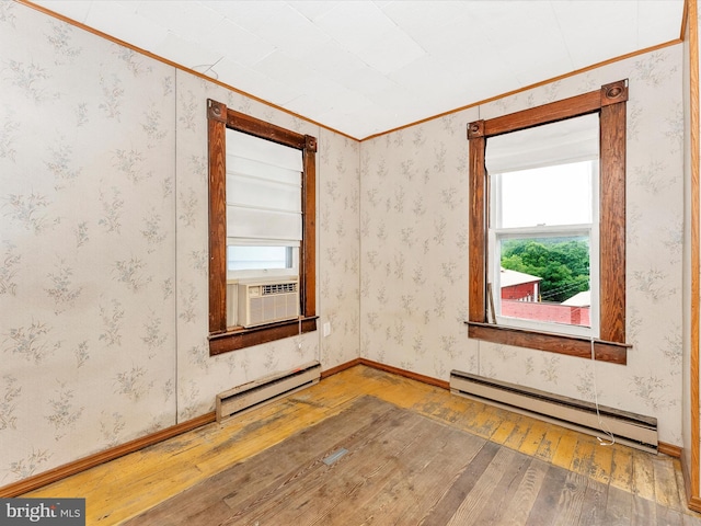 526 W Potomac St, Brunswick, MD 21716 - empty room featuring a baseboard heating unit, wood-type flooring, cooling unit, and crown molding