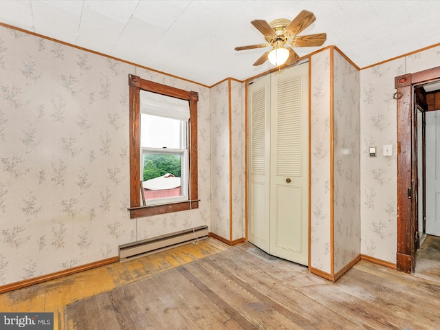 526 W Potomac St, Brunswick, MD 21716 - unfurnished bedroom featuring a baseboard heating unit, wood-type flooring, crown molding, a closet, and ceiling fan
