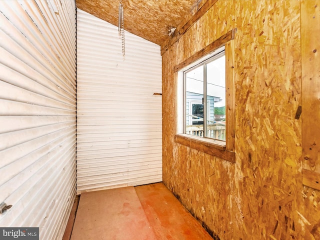 526 W Potomac St, Brunswick, MD 21716 - spare room featuring concrete floors, lofted ceiling, and wooden walls