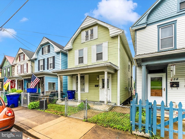526 W Potomac St, Brunswick, MD 21716 - view of front of property featuring a porch, a gate, a fenced front yard, and a residential view