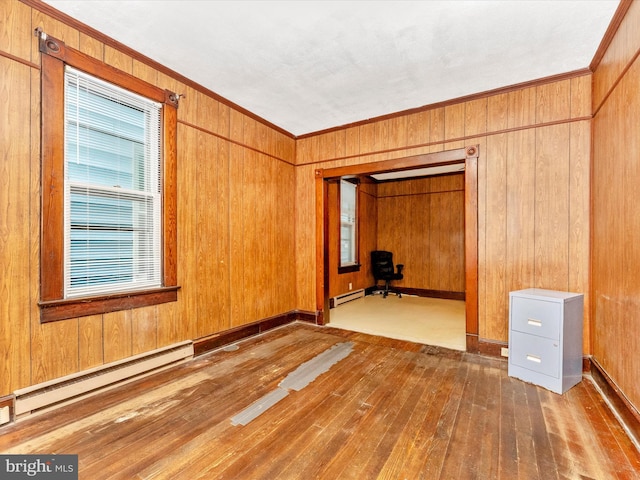 526 W Potomac St, Brunswick, MD 21716 - unfurnished room with hardwood / wood-style floors, a baseboard radiator, ornamental molding, and wood walls