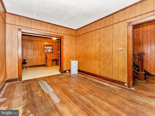 526 W Potomac St, Brunswick, MD 21716 - spare room with hardwood / wood-style flooring, ornamental molding, and wooden walls
