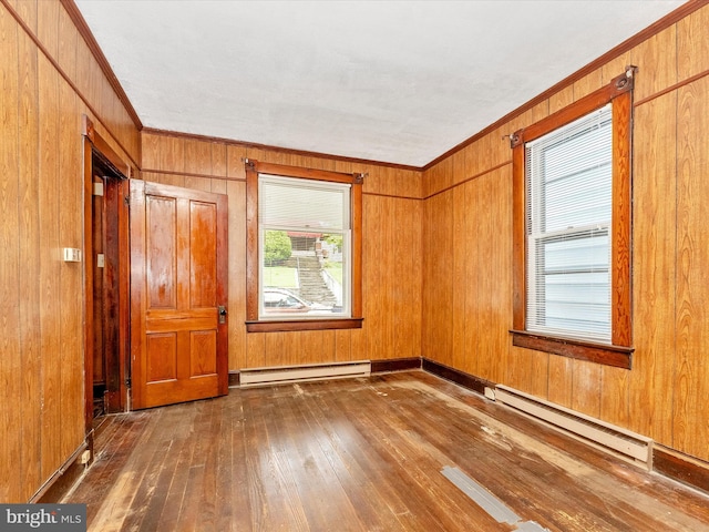 526 W Potomac St, Brunswick, MD 21716 - empty room featuring a baseboard radiator, hardwood / wood-style flooring, crown molding, and wood walls