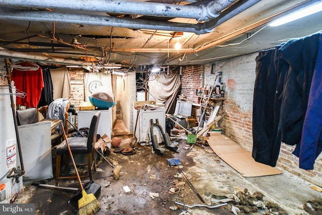 44 Q St NE, Washington, DC 20002 - unfinished below grade area featuring gas water heater, brick wall, and separate washer and dryer