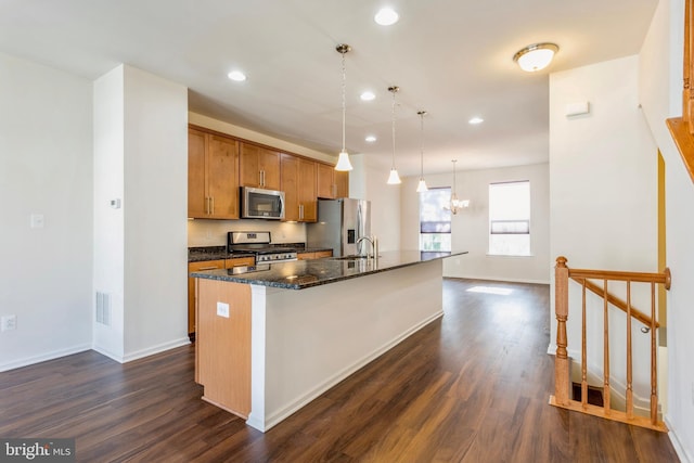 519 Long Wall Dr, Reisterstown, MD 21136 - kitchen with appliances with stainless steel finishes, a center island with sink, dark wood-style flooring, recessed lighting, and brown cabinetry