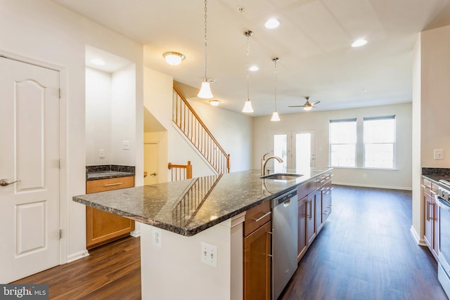 519 Long Wall Dr, Reisterstown, MD 21136 - kitchen with stainless steel appliances, dark wood-type flooring, ceiling fan, dark stone counters, and a center island with sink