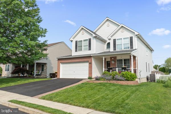 2032 Valley View Dr, Quakertown, PA 18951 - traditional home featuring covered porch, brick siding, asphalt driveway, and an attached garage