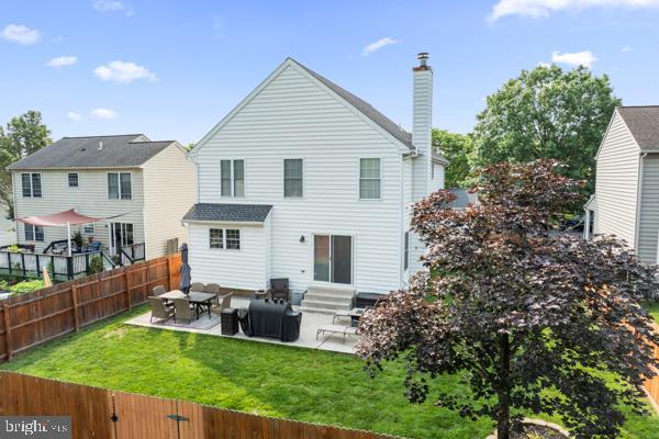 2032 Valley View Dr, Quakertown, PA 18951 - back of property with entry steps, a patio area, and a chimney