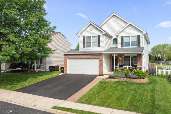 2032 Valley View Dr, Quakertown, PA 18951 - traditional home featuring brick siding, asphalt driveway, covered porch, and an attached garage