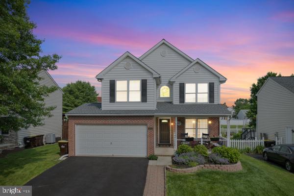 2032 Valley View Dr, Quakertown, PA 18951 - traditional-style home with covered porch, brick siding, driveway, and a garage