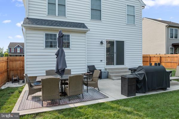 2032 Valley View Dr, Quakertown, PA 18951 - back of property with entry steps, a fenced backyard, a shingled roof, and a patio area