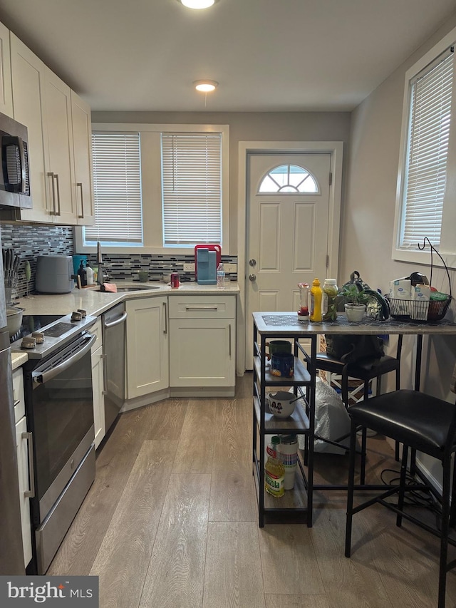 1837 E Venango St, Philadelphia, PA 19134 - kitchen featuring appliances with stainless steel finishes, light wood-style floors, light countertops, and a sink