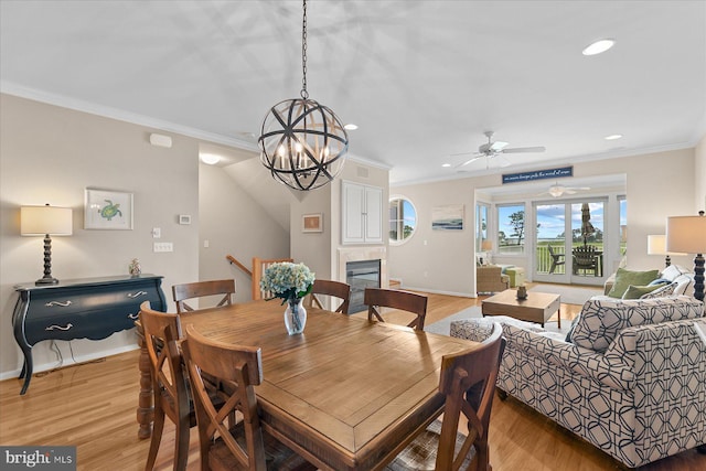 38336 Ocean Vista Dr Unit 1098, Selbyville, DE 19975 - dining area featuring recessed lighting, light wood-type flooring, a tile fireplace, crown molding, and ceiling fan