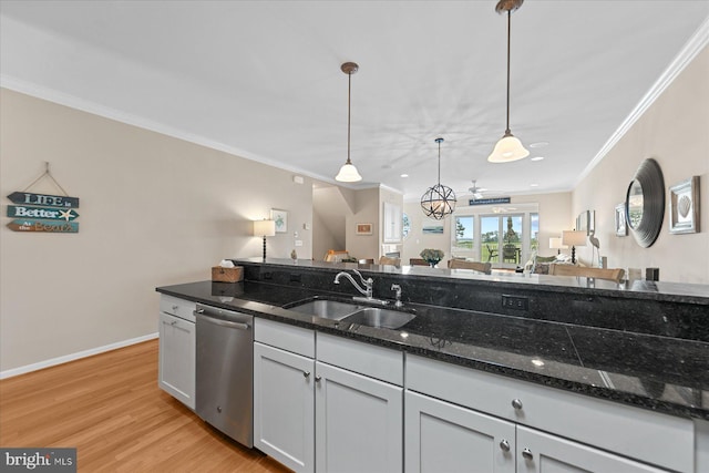 38336 Ocean Vista Dr Unit 1098, Selbyville, DE 19975 - kitchen with stainless steel dishwasher, crown molding, light wood-style floors, pendant lighting, and dark stone countertops