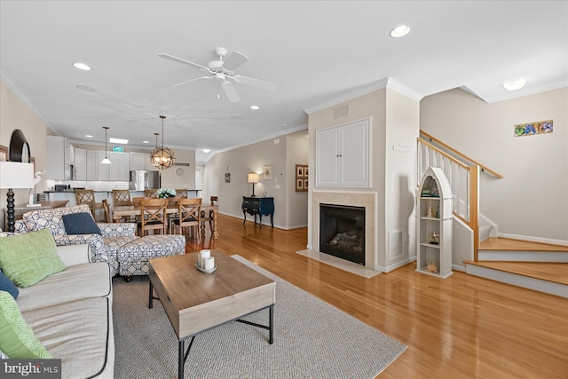38336 Ocean Vista Dr Unit 1098, Selbyville, DE 19975 - living room with ornamental molding, ceiling fan, stairs, light wood-type flooring, and recessed lighting