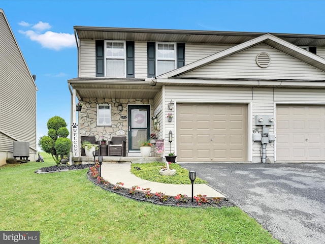 2 Marsha Dr, Cressona, PA 17929 - view of front of property with driveway, a front yard, a porch, stone siding, and a garage