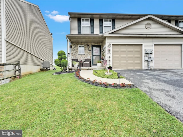2 Marsha Dr, Cressona, PA 17929 - view of front of property with driveway, a front yard, stone siding, a porch, and an attached garage
