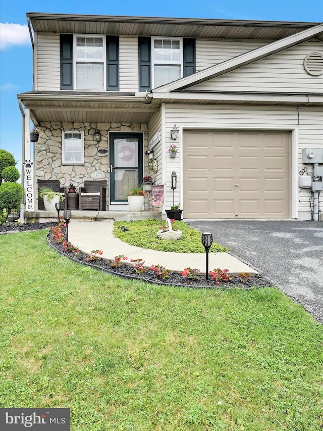 2 Marsha Dr, Cressona, PA 17929 - view of front of property with asphalt driveway, a front lawn, a garage, covered porch, and stone siding