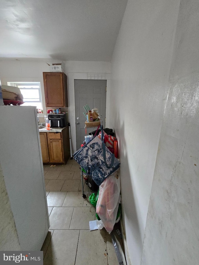 2513 W Sergeant St, Philadelphia, PA 19132 - bedroom with freestanding refrigerator and light tile patterned floors