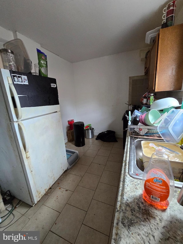 2513 W Sergeant St, Philadelphia, PA 19132 - kitchen featuring freestanding refrigerator and light tile patterned floors