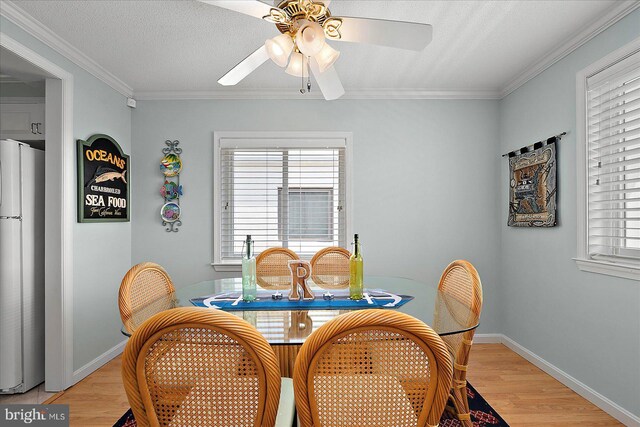 11603 Seaward Rd Unit 6, Ocean City, MD 21842 - dining area with light wood-type flooring, ceiling fan, and crown molding